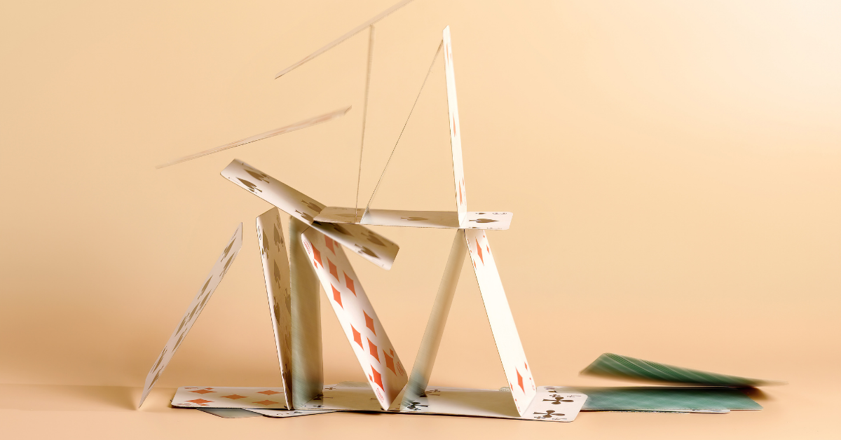 Image of a house of cards being toppled down